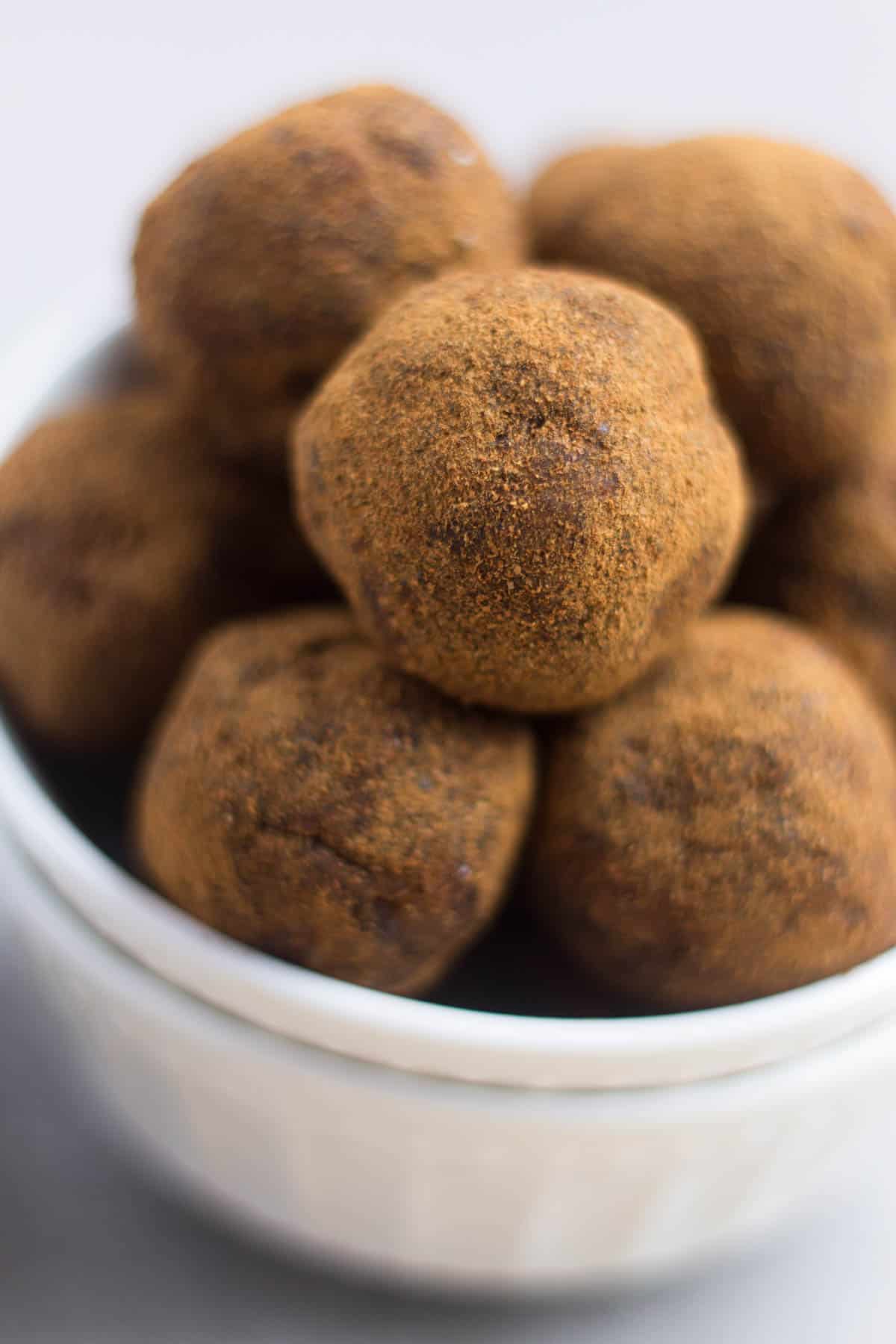 Classic fall flavors make their way into these Pumpkin Cinnamon Raisin Balls for the perfect snack or energy ball pick-me-up. Vegan, paleo, and Whole30 approved! - Eat the Gains