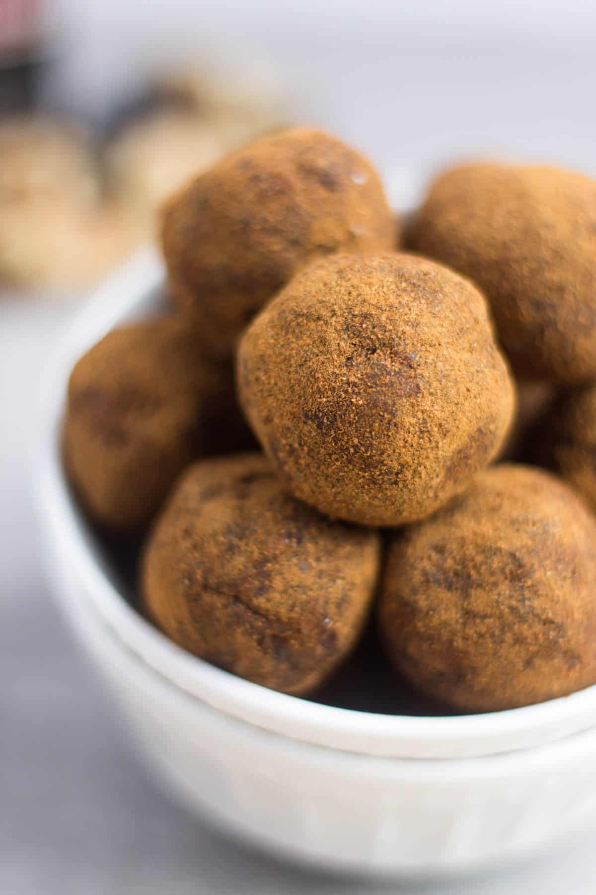 Classic fall flavors make their way into these Pumpkin Cinnamon Raisin Balls for the perfect snack or energy ball pick-me-up. Vegan, paleo, and Whole30 approved! - Eat the Gains