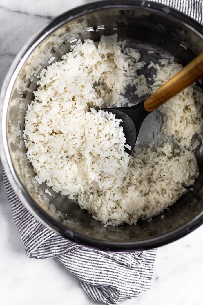 An instant pot filled with cooked coconut cilantro lime rice.