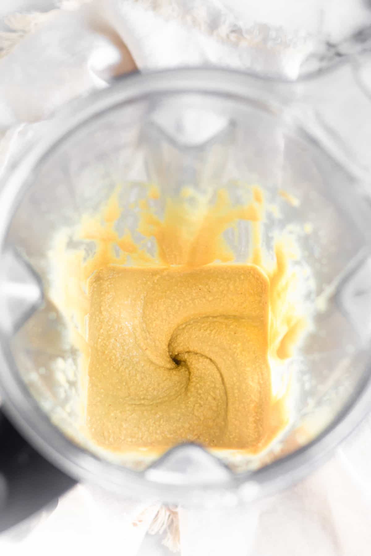 A blender filled with freshly blended cashew coconut butter