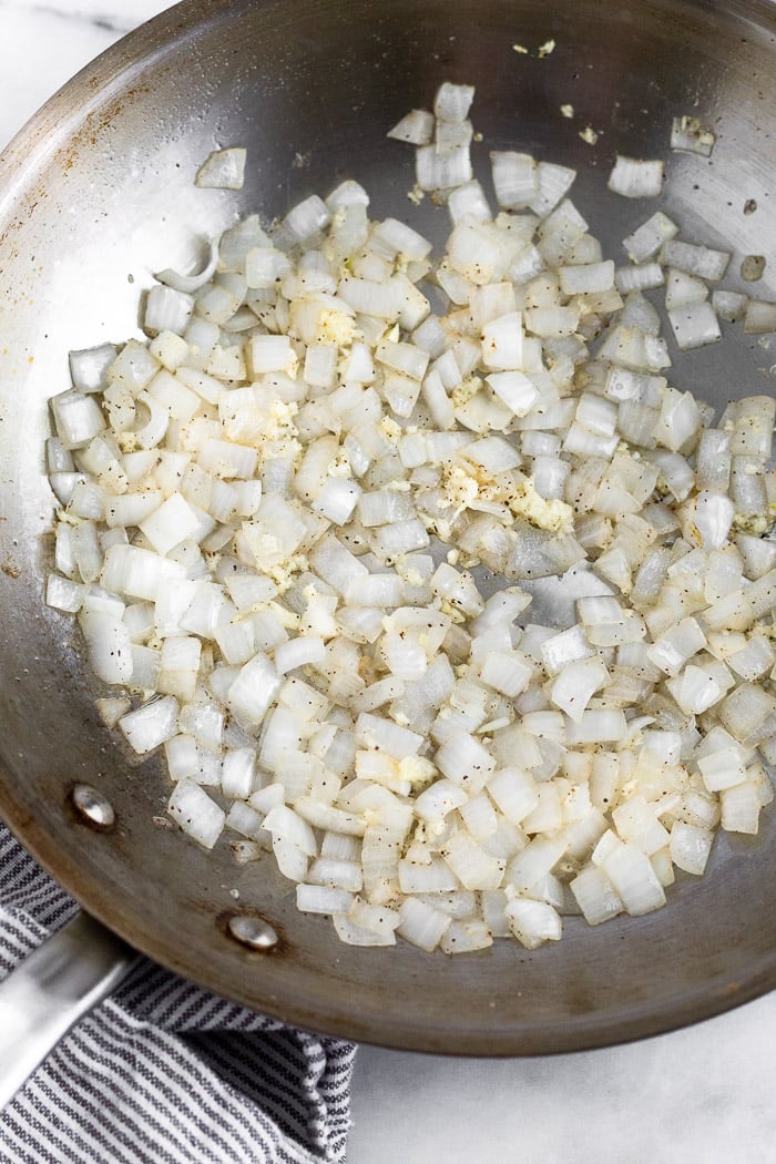 A large saute pan of sautéed onions.