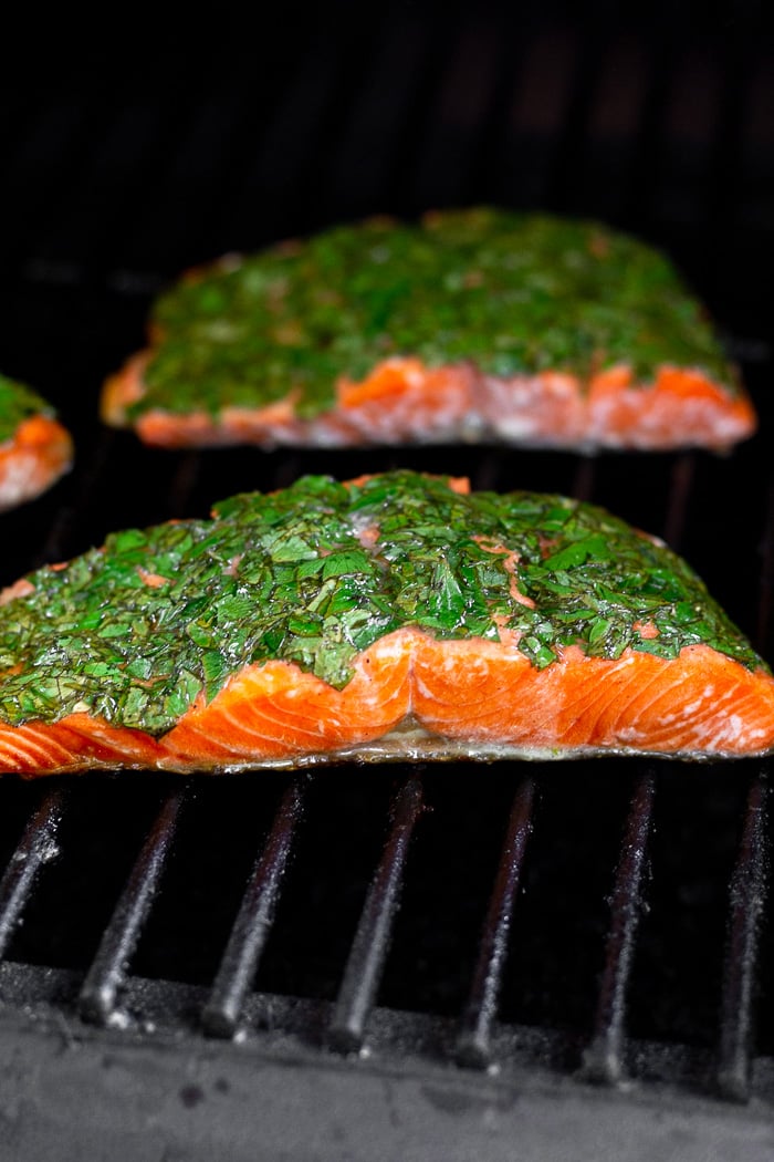 Salmon on the grill covered with fresh herbs.