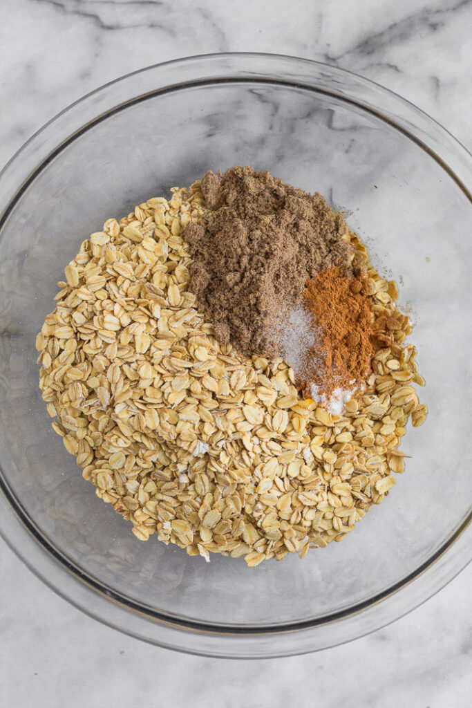 Overhead shot of rolled oats, ground flaxseed, cinnamon, and salt.