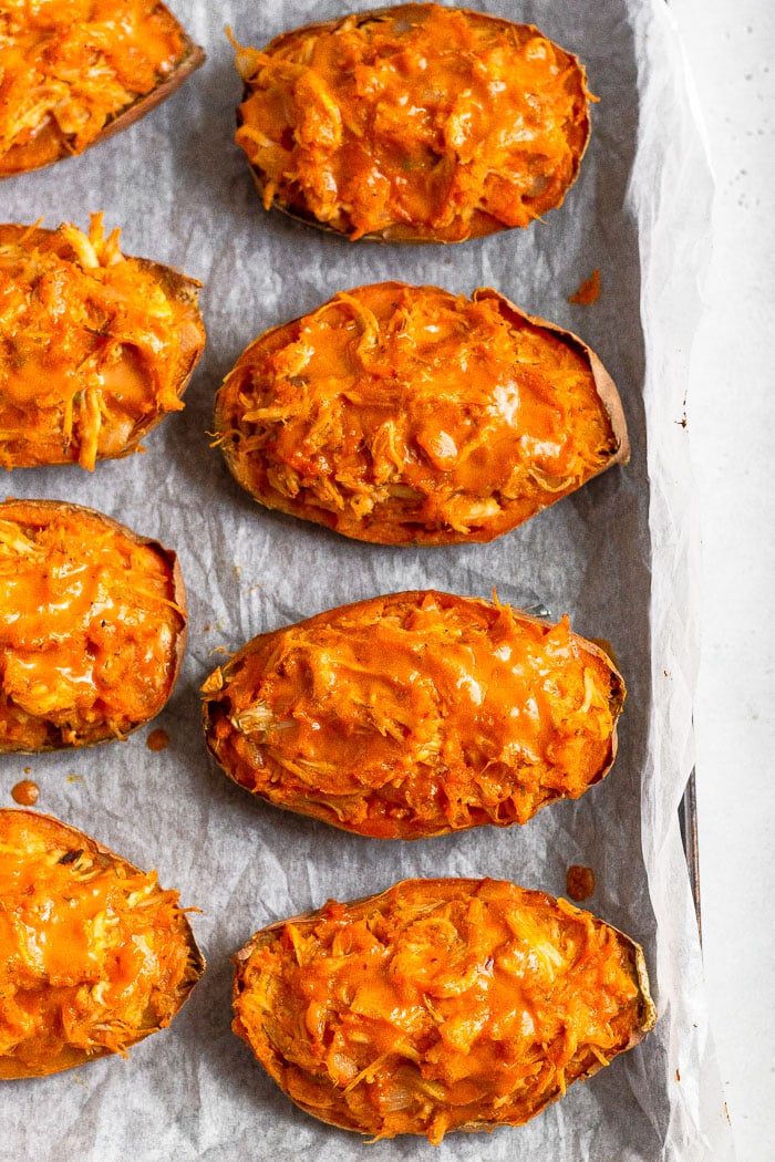 Overhead shot of twice baked sweet potatoes on a baking sheet.