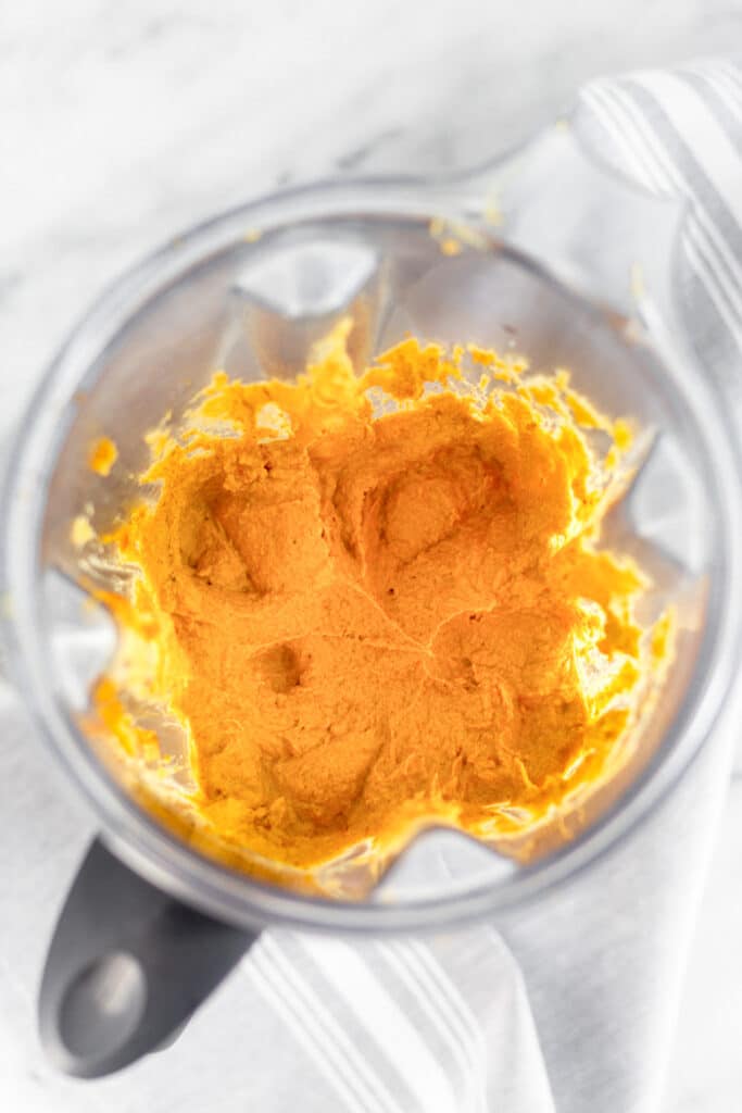 Overhead shot of a blender filled with pumpkin pie butter in it.
