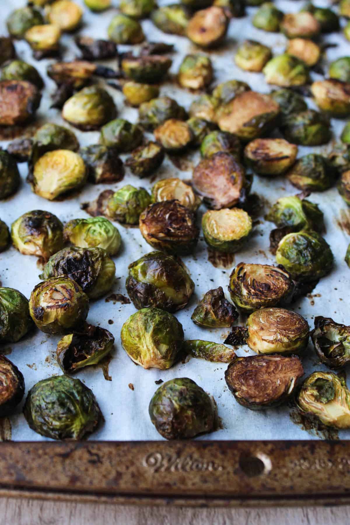 These Ginger & Balsamic Roasted Brussels Sprouts with Pomegranates are an easy & healthy side dish that are just as festive as the holiday season - Eat the Gains