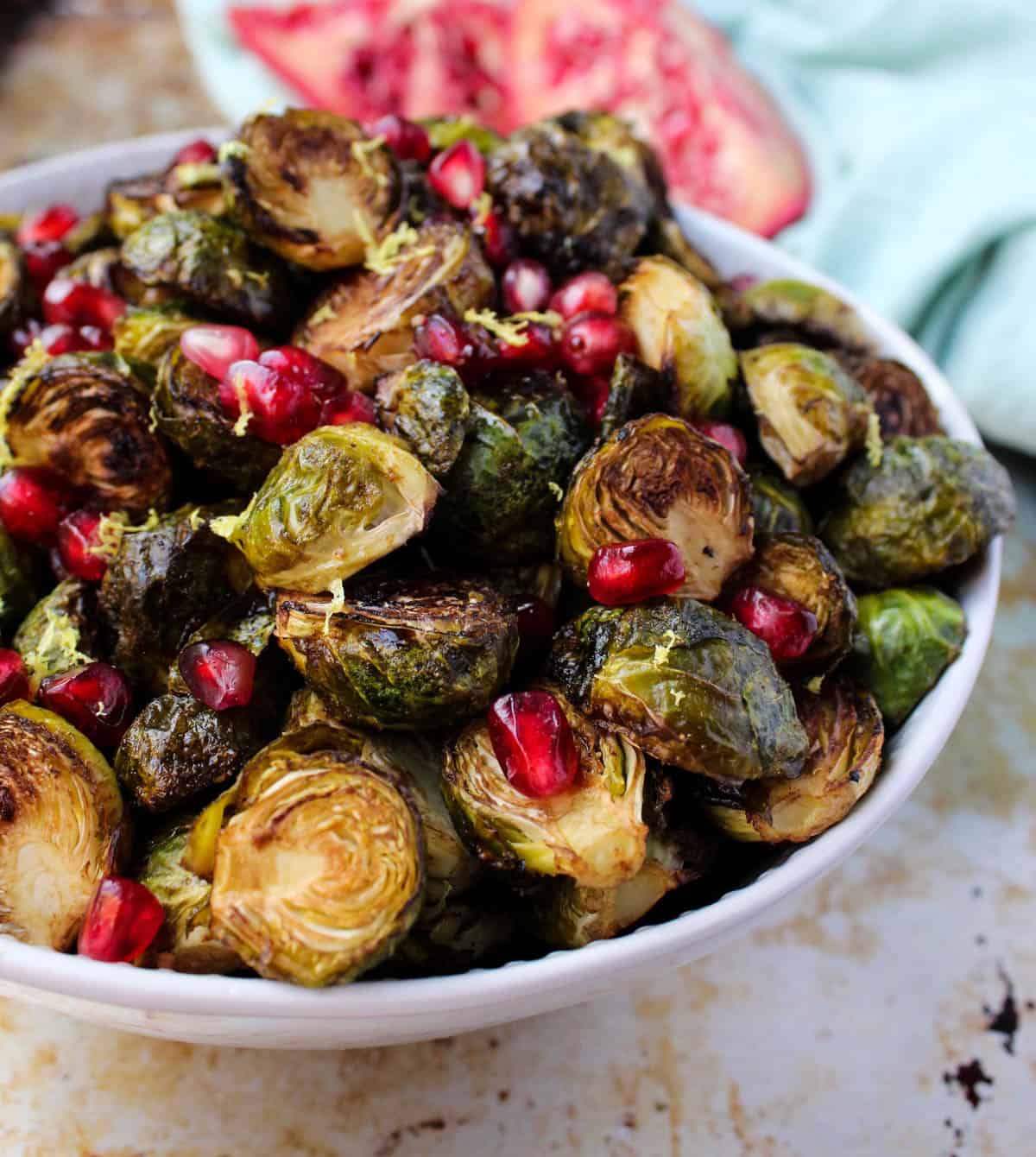 These Ginger & Balsamic Roasted Brussels Sprouts with Pomegranates are an easy & healthy side dish that are just as festive as the holiday season - Eat the Gains
