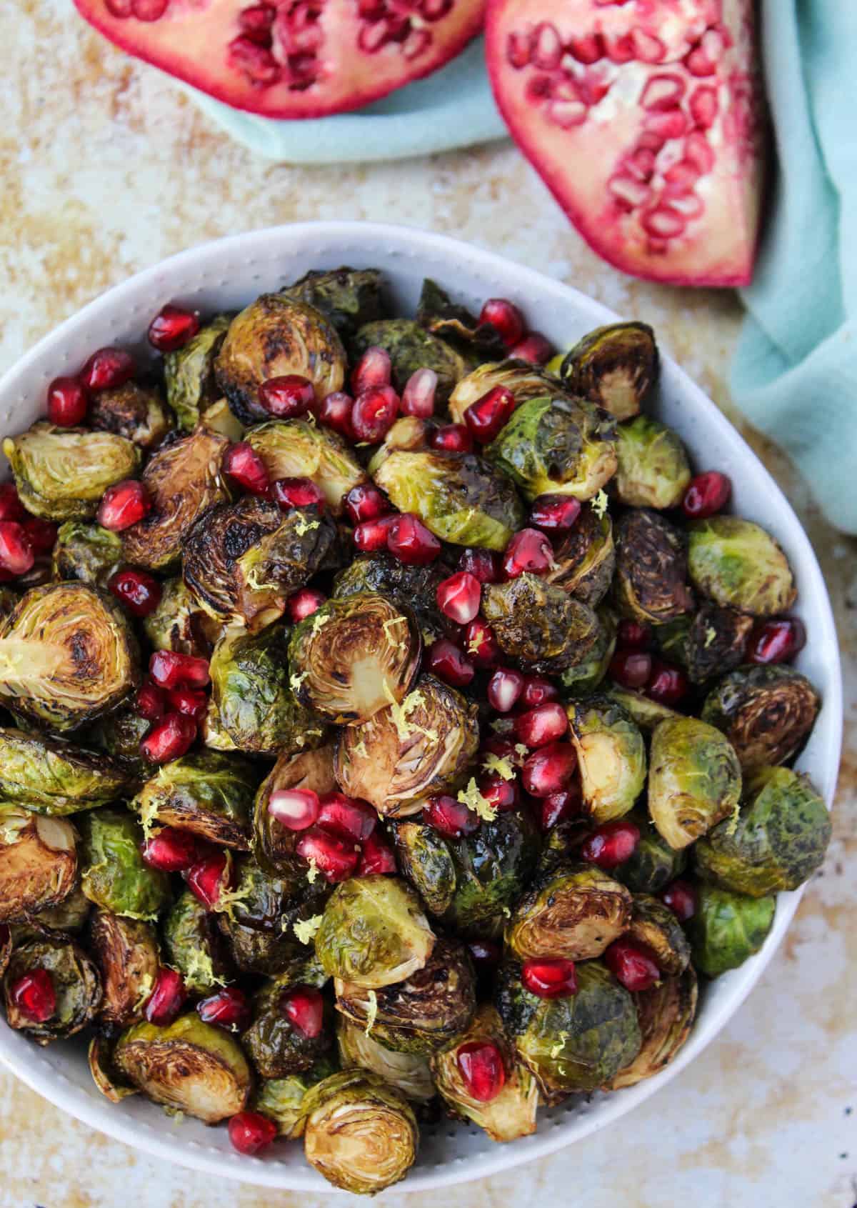 These Ginger & Balsamic Roasted Brussels Sprouts with Pomegranates are an easy & healthy side dish that are just as festive as the holiday season - Eat the Gains