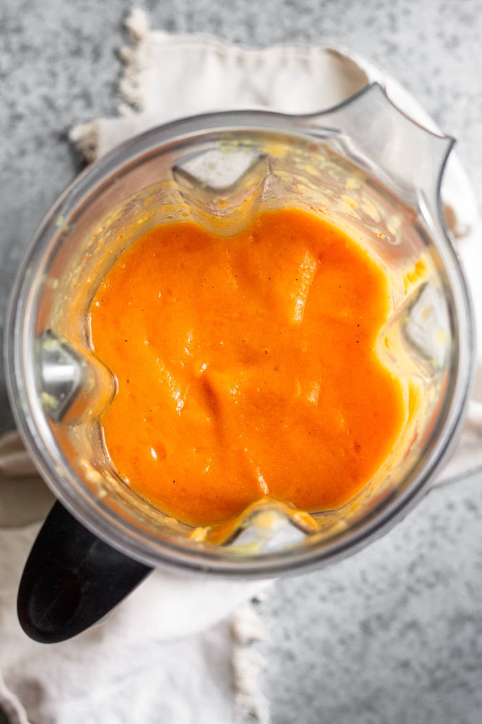 Blender filled with roasted acorn squash soup.