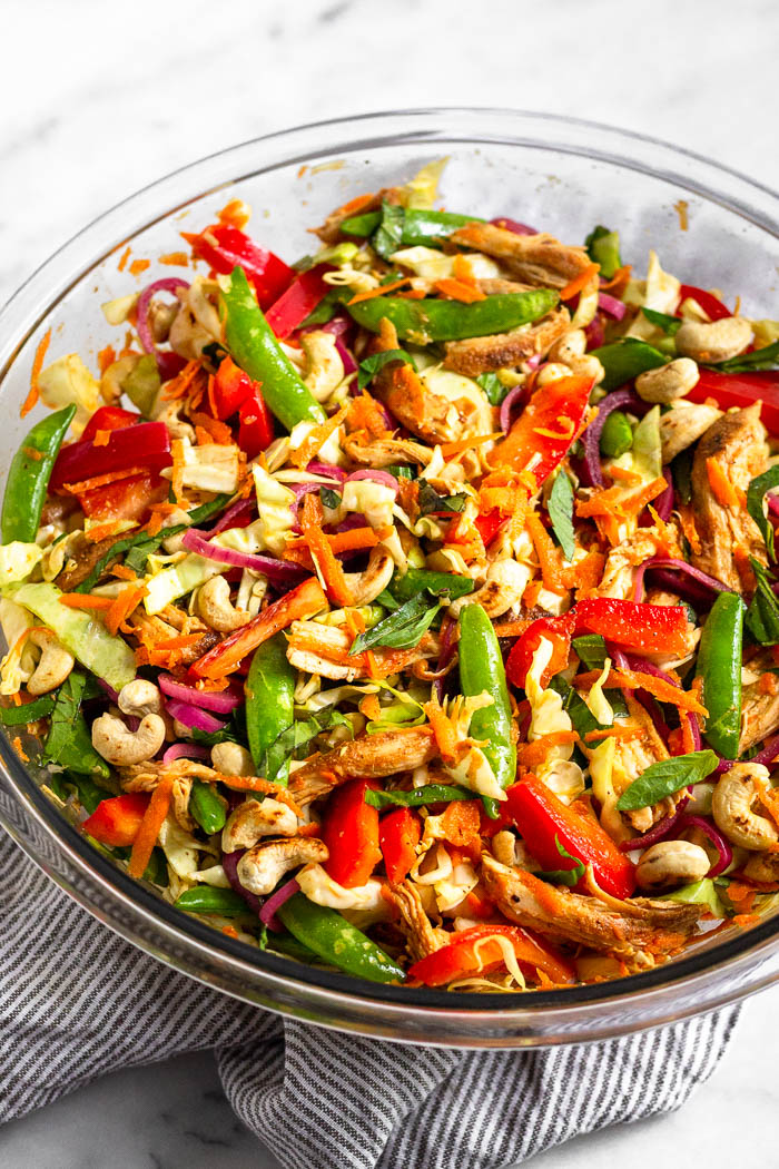 Large glass bowl filled with Vietnamese chicken cabbage salad all mixed up.