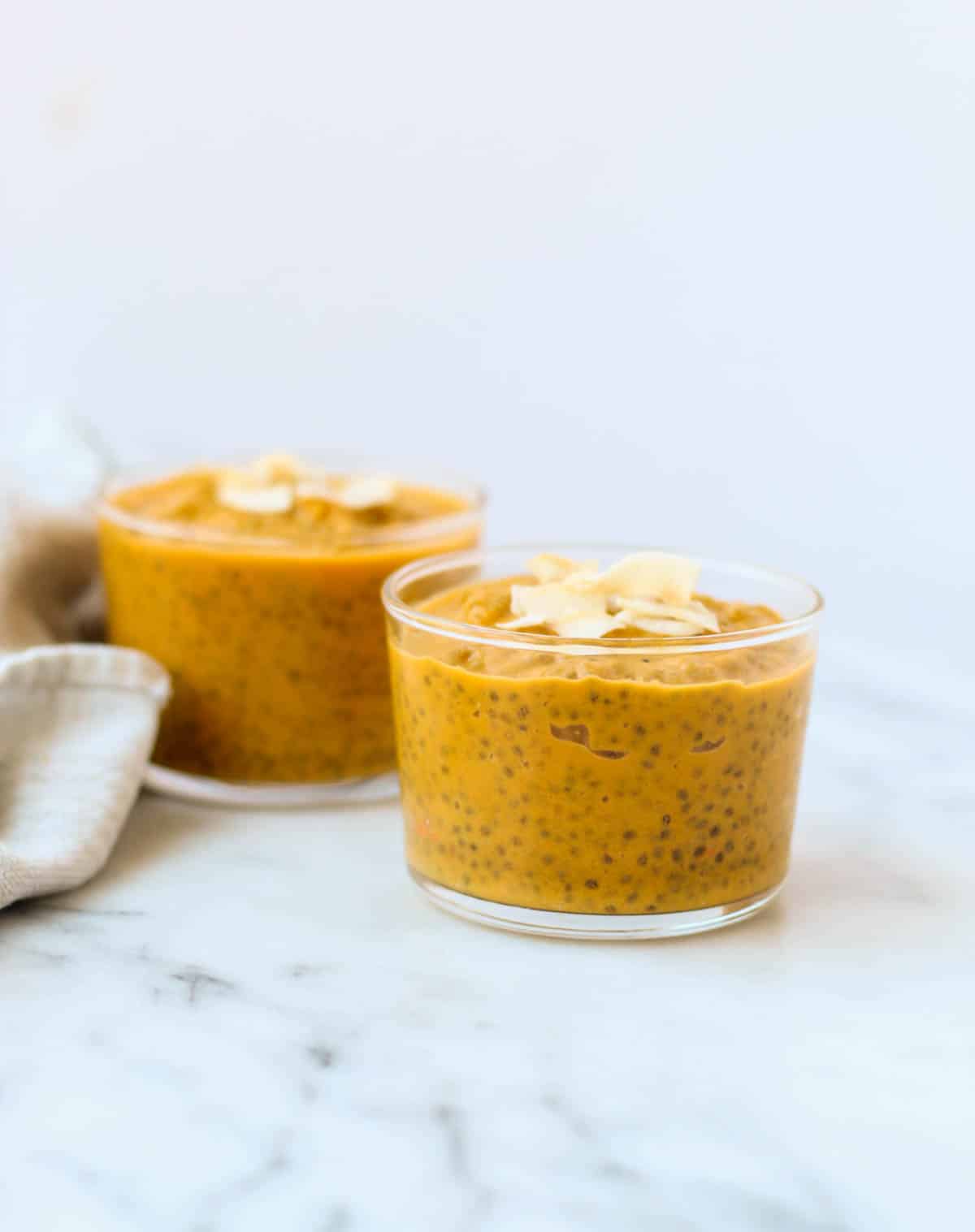 This Carrot Cake Chia Pudding takes the flavors of a classic dessert and turns it into a healthy snack that is paleo, vegan, and dairy & gluten free - Eat the Gains