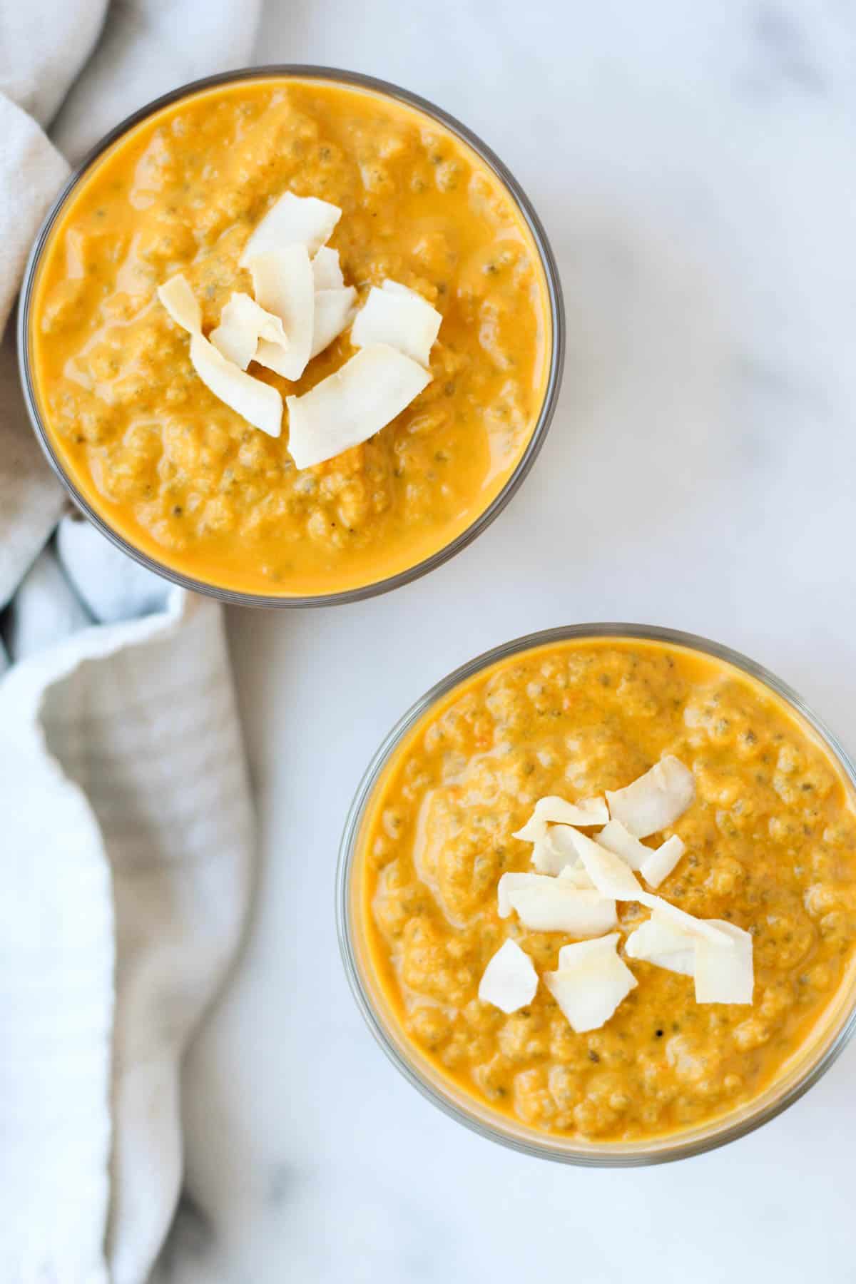 This Carrot Cake Chia Pudding takes the flavors of a classic dessert and turns it into a healthy snack that is paleo, vegan, and dairy & gluten free - Eat the Gains