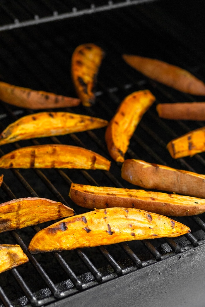 Sweet potatoes wedges cooking on the grill