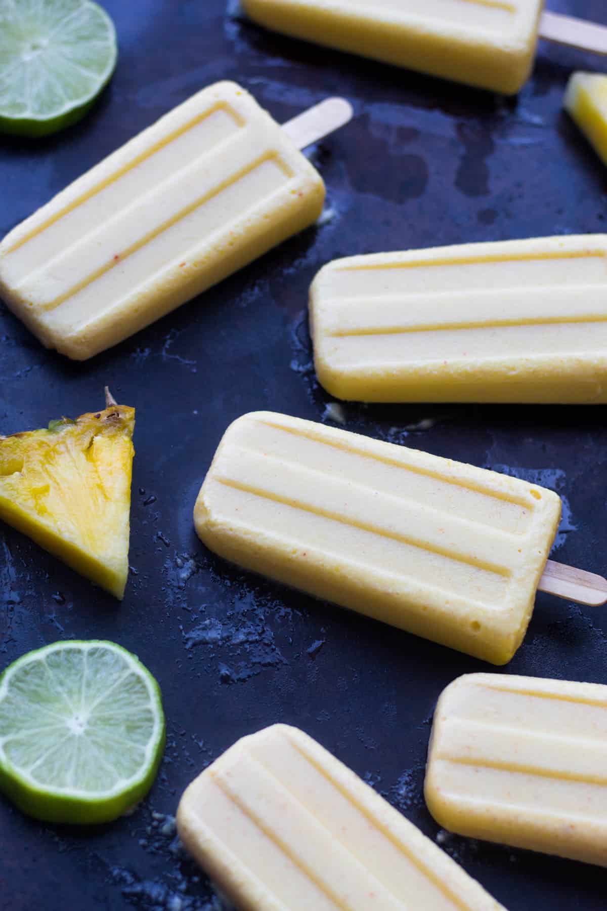 4 ingredient Pineapple Popsicles make an easy and healthy summertime treat. They are vegan, paleo, and sweetener free! - Eat the Gains