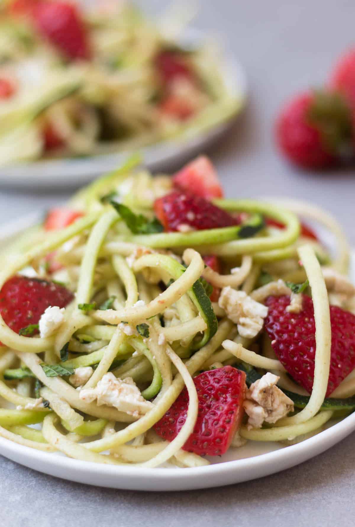 This Strawberry Zucchini Noodle Salad comes together in less than 10 minutes and makes a healthy, easy, and gluten free summertime dish - Eat the Gains