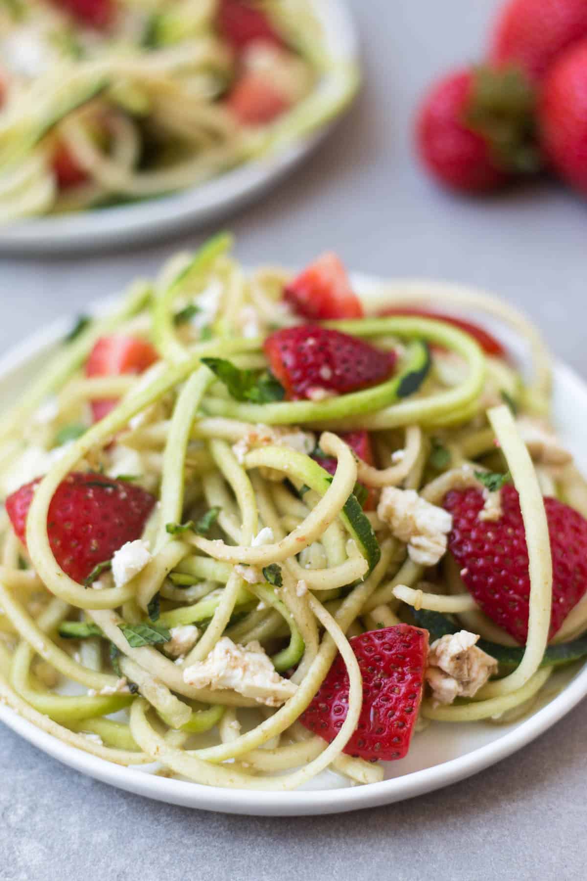This Strawberry Zucchini Noodle Salad comes together in less than 10 minutes and makes a healthy, easy, and gluten free summertime dish - Eat the Gains
