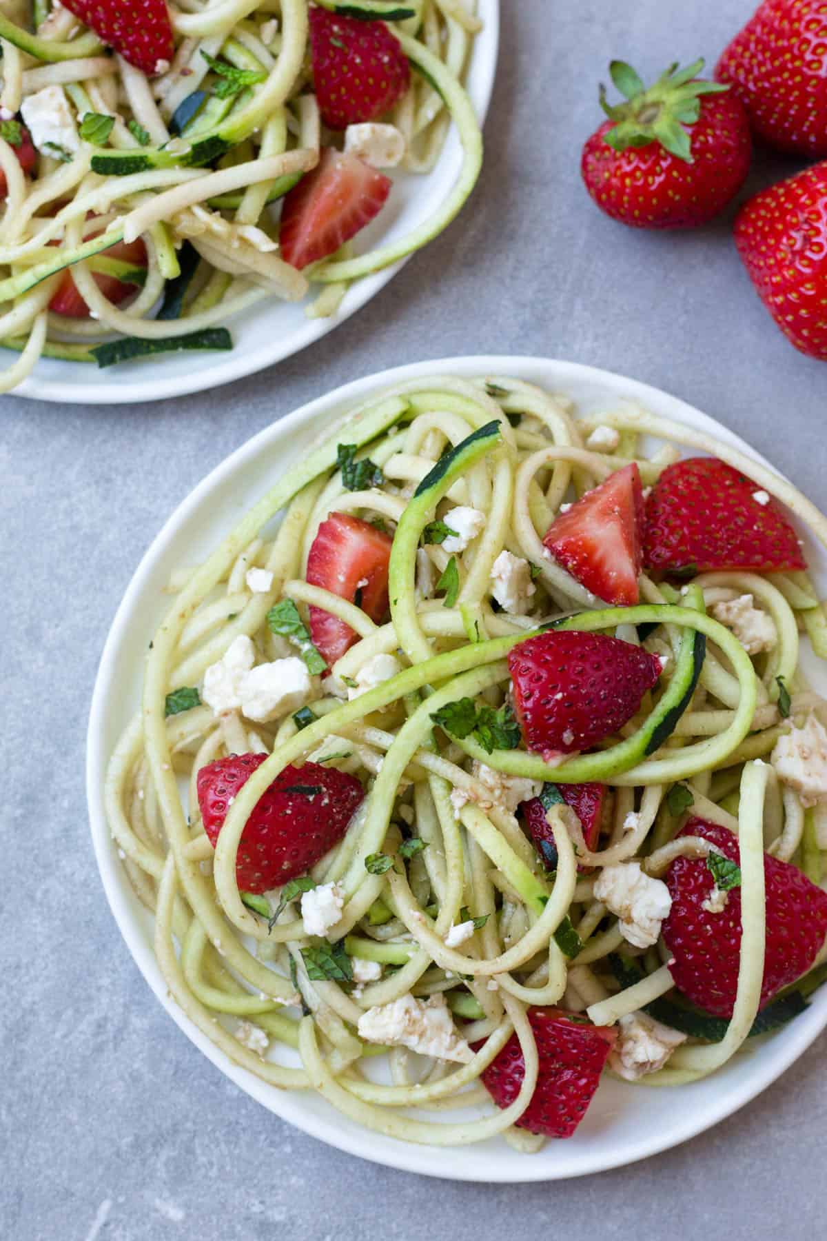 This Strawberry Zucchini Noodle Salad comes together in less than 10 minutes and makes a healthy, easy, and gluten free summertime dish - Eat the Gains