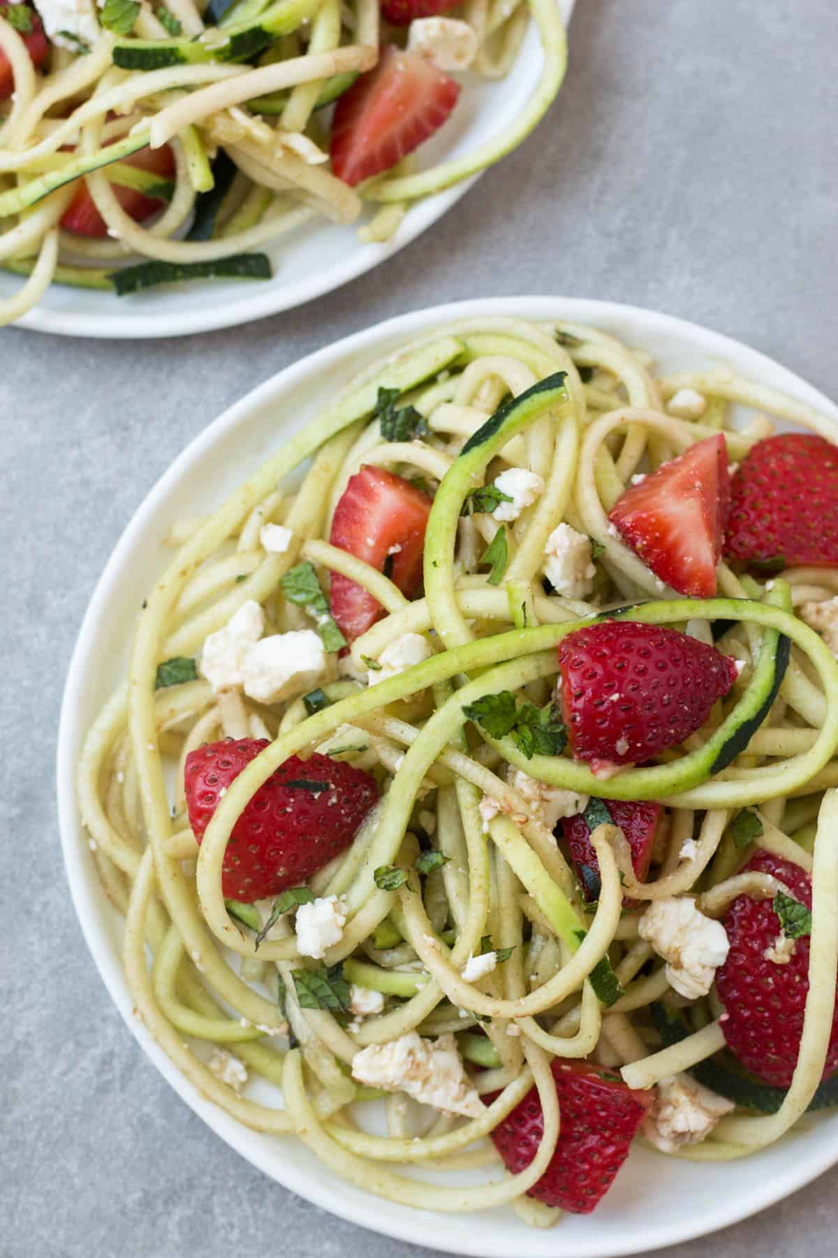 This Strawberry Zucchini Noodle Salad comes together in less than 10 minutes and makes a healthy, easy, and gluten free summertime dish - Eat the Gains