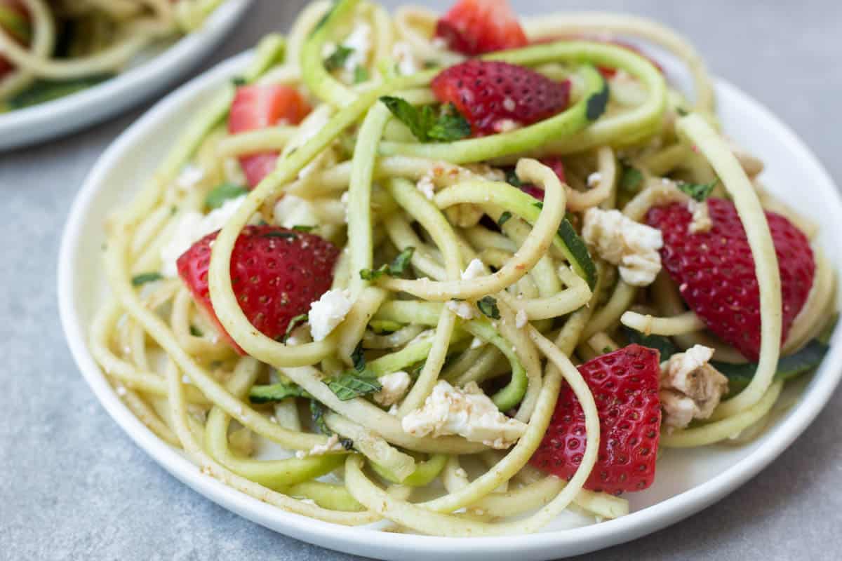 This Strawberry Zucchini Noodle Salad comes together in less than 10 minutes and makes a healthy, easy, and gluten free summertime dish - Eat the Gains