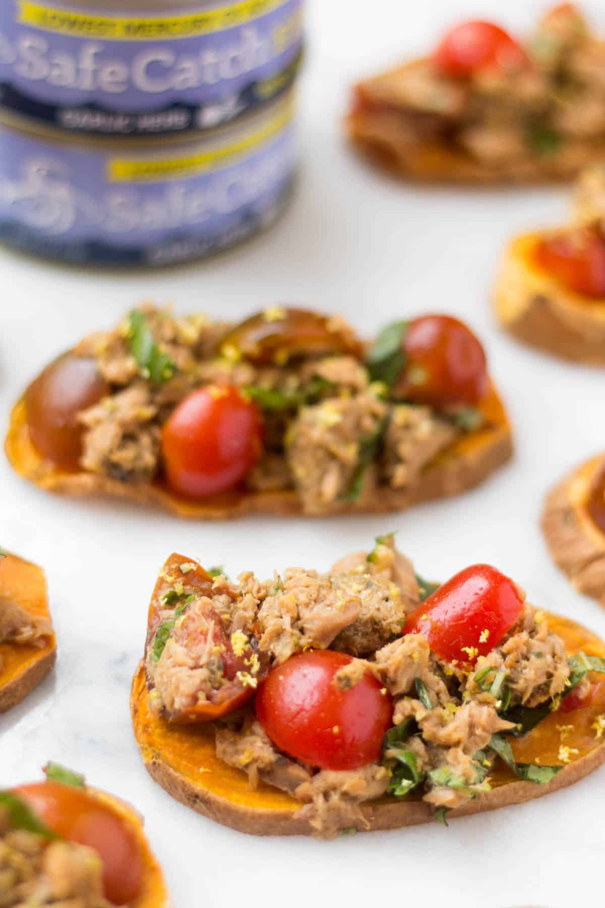 A paleo and Whole30 approved protein packed, this Tuna Bruschetta on Sweet Potato Toast makes easy, healthy, and crowd pleasing appetizer or snack! - Eat the Gains