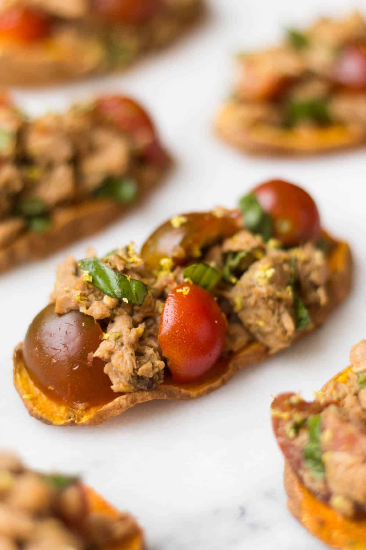 A paleo and Whole30 approved protein packed, this Tuna Bruschetta on Sweet Potato Toast makes easy, healthy, and crowd pleasing appetizer or snack! - Eat the Gains