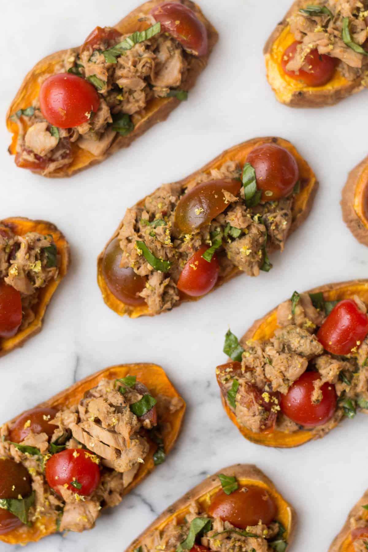 A paleo and Whole30 approved protein packed, this Tuna Bruschetta on Sweet Potato Toast makes easy, healthy, and crowd pleasing appetizer or snack! - Eat the Gains