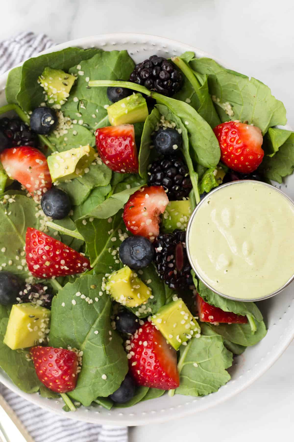 A perfect easy & light end of summer dish, this Berry Avocado Salad with Creamy Matcha Dressing packs the nutrients & is paleo, vegan, dairy free, & Whole30 approved! - Eat the Gains