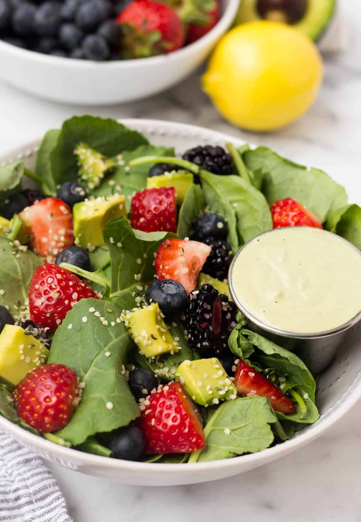 A perfect easy & light end of summer dish, this Berry Avocado Salad with Creamy Matcha Dressing packs the nutrients & is paleo, vegan, dairy free, & Whole30 approved! - Eat the Gains