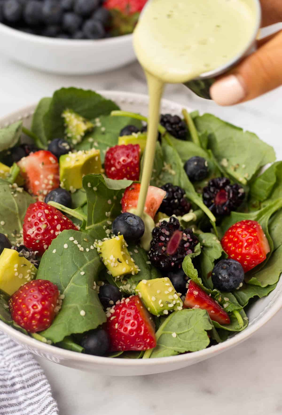 A perfect easy & light end of summer dish, this Berry Avocado Salad with Creamy Matcha Dressing packs the nutrients & is paleo, vegan, dairy free, & Whole30 approved! - Eat the Gains