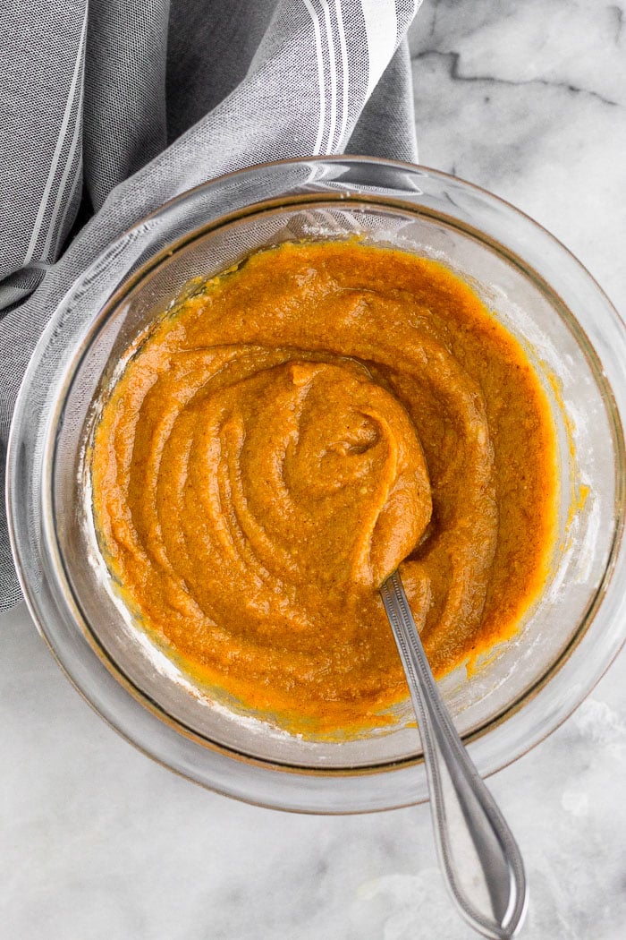 Glass bowl with batter for paleo pumpkin protein pancakes with a fork sticking out of it.
