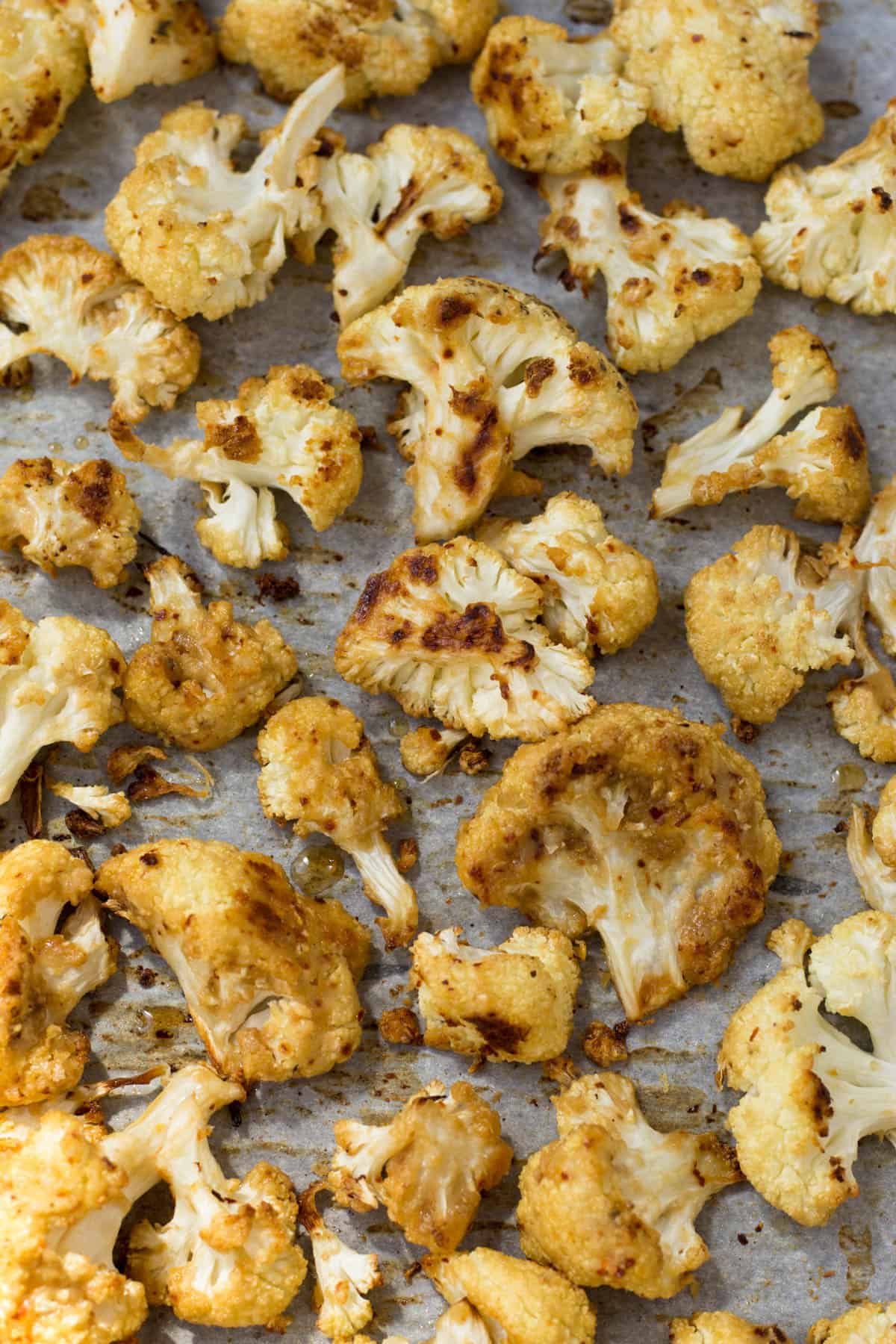 This vegan and paleo Maple Tahini Roasted Cauliflower make for an easy sweet and savory side dish - Eat the Gains