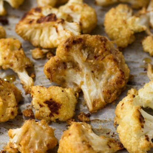 This vegan and paleo Maple Tahini Roasted Cauliflower make for an easy sweet and savory side dish - Eat the Gains