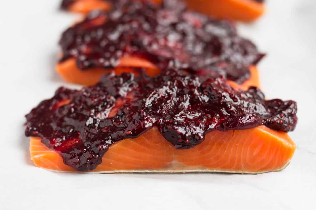 An easy and festive seafood dish, this Cranberry Balsamic Roasted Salmon takes 15 minutes, 4 ingredients, and is a crowd pleaser for the holidays - paleo and Whole30 approved! - Eat the Gains