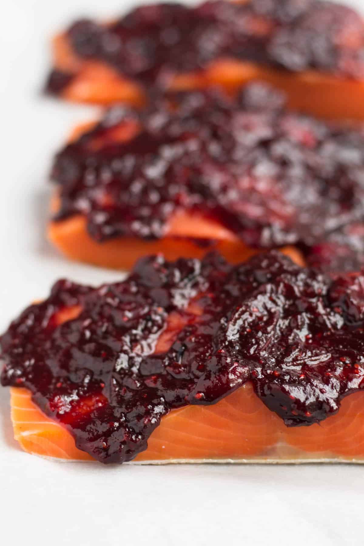 An easy and festive seafood dish, this Cranberry Balsamic Roasted Salmon takes 15 minutes, 4 ingredients, and is a crowd pleaser for the holidays - paleo and Whole30 approved! - Eat the Gains