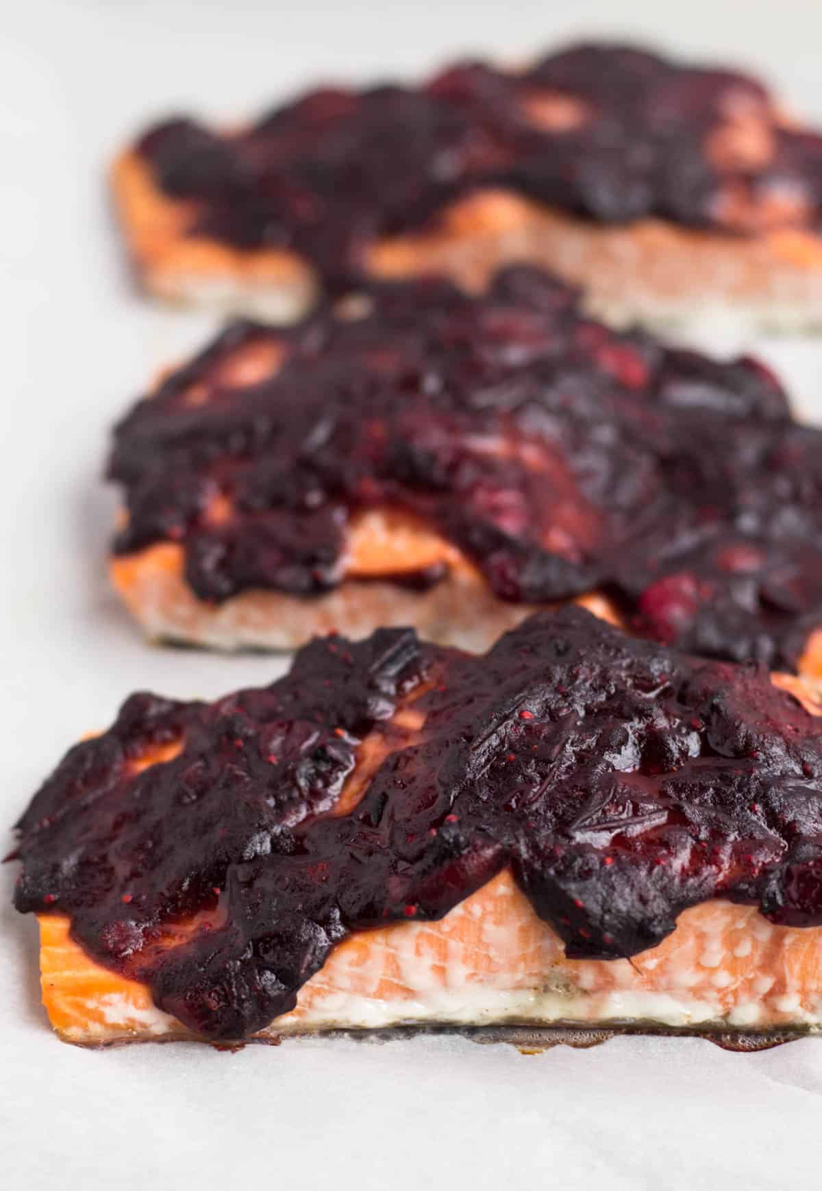 An easy and festive seafood dish, this Cranberry Balsamic Roasted Salmon takes 15 minutes, 4 ingredients, and is a crowd pleaser for the holidays - paleo and Whole30 approved! - Eat the Gains