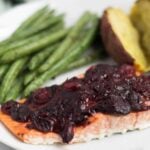An easy and festive seafood dish, this Cranberry Balsamic Roasted Salmon takes 15 minutes and is a crowd pleaser for the holidays - paleo, gluten free, and Whole30 approved! - Eat the Gain