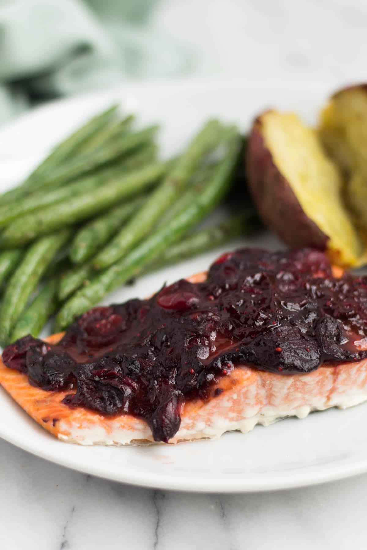 An easy and festive seafood dish, this Cranberry Balsamic Roasted Salmon takes 15 minutes, 4 ingredients, and is a crowd pleaser for the holidays - paleo and Whole30 approved! - Eat the Gains