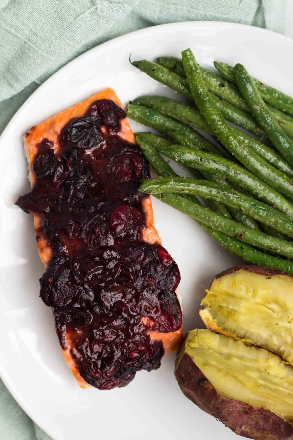 An easy and festive seafood dish, this Cranberry Balsamic Roasted Salmon takes 15 minutes, 4 ingredients, and is a crowd pleaser for the holidays - paleo and Whole30 approved! - Eat the Gains