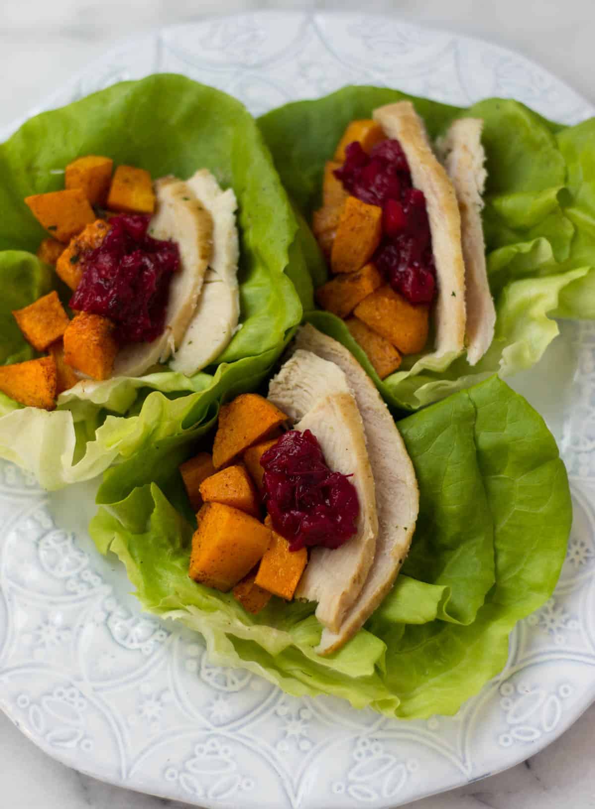 A lightened up version of your thanksgiving leftover sandwich, Turkey Cranberry Lettuce Wraps make a great low carb, gluten free, paleo, and Whole30 meal! - Eat the Gains