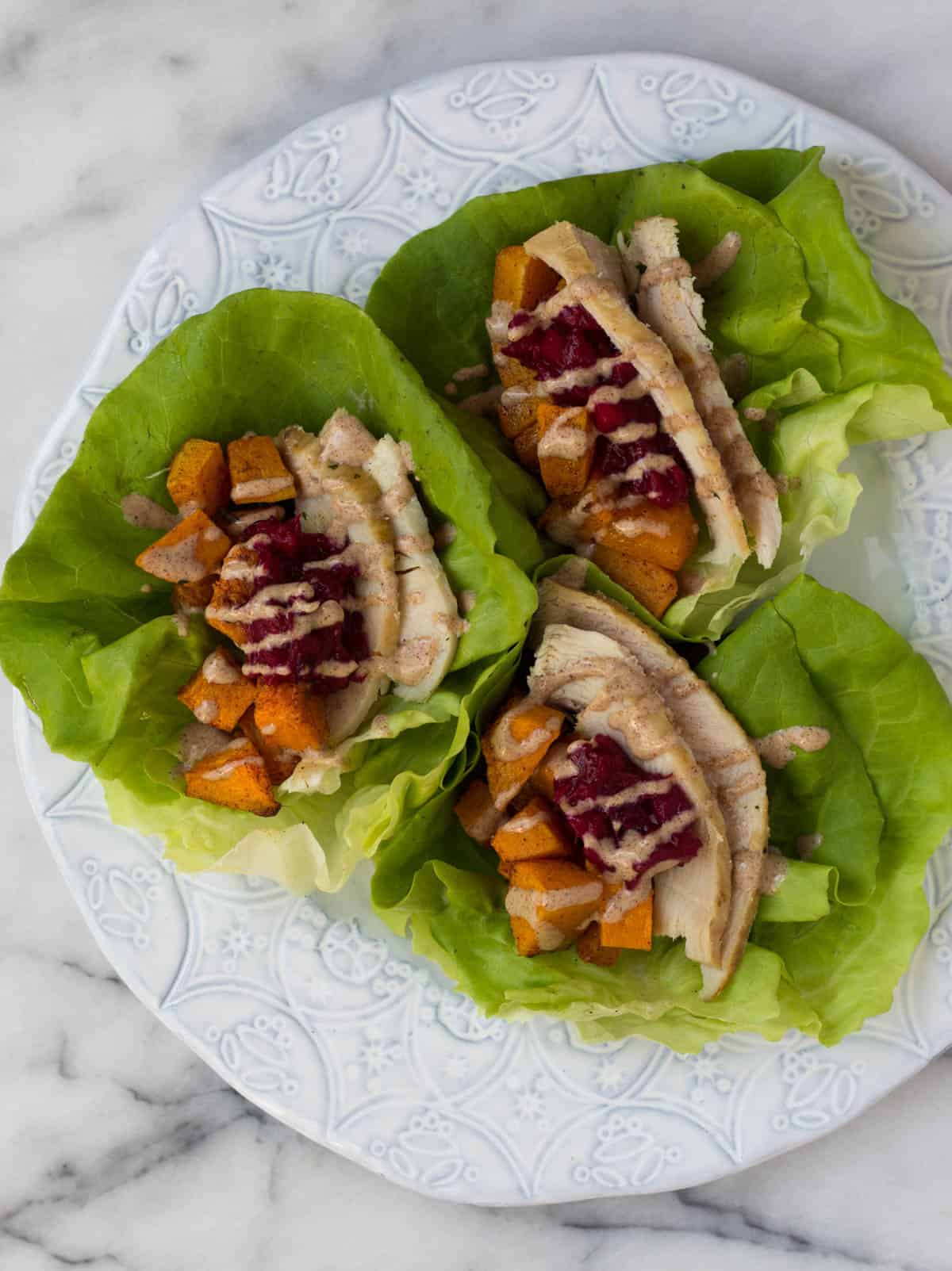 A lightened up version of your thanksgiving leftover sandwich, Turkey Cranberry Lettuce Wraps make a great low carb, gluten free, paleo, and Whole30 meal! - Eat the Gains