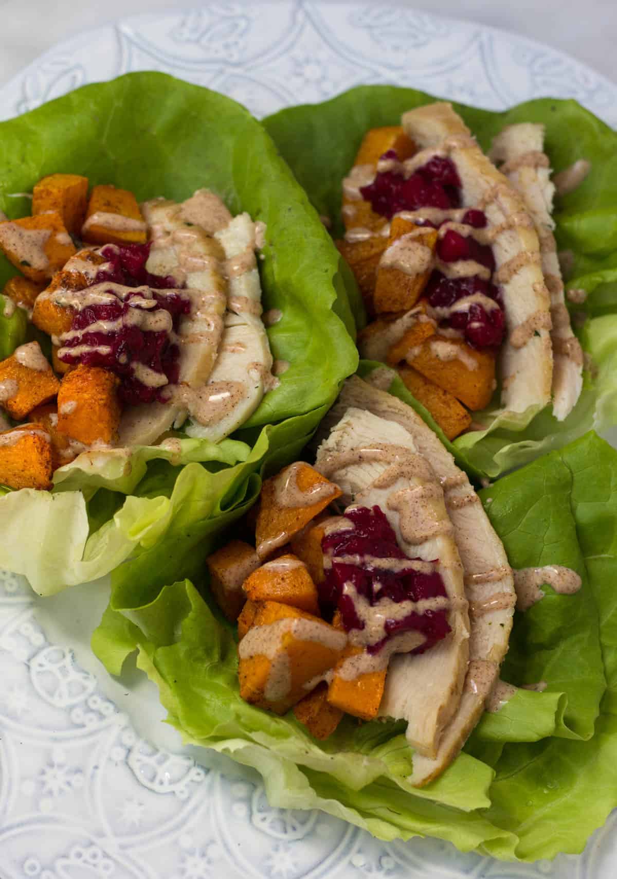 A lightened up version of your thanksgiving leftover sandwich, Turkey Cranberry Lettuce Wraps make a great low carb, gluten free, paleo, and Whole30 meal! - Eat the Gains