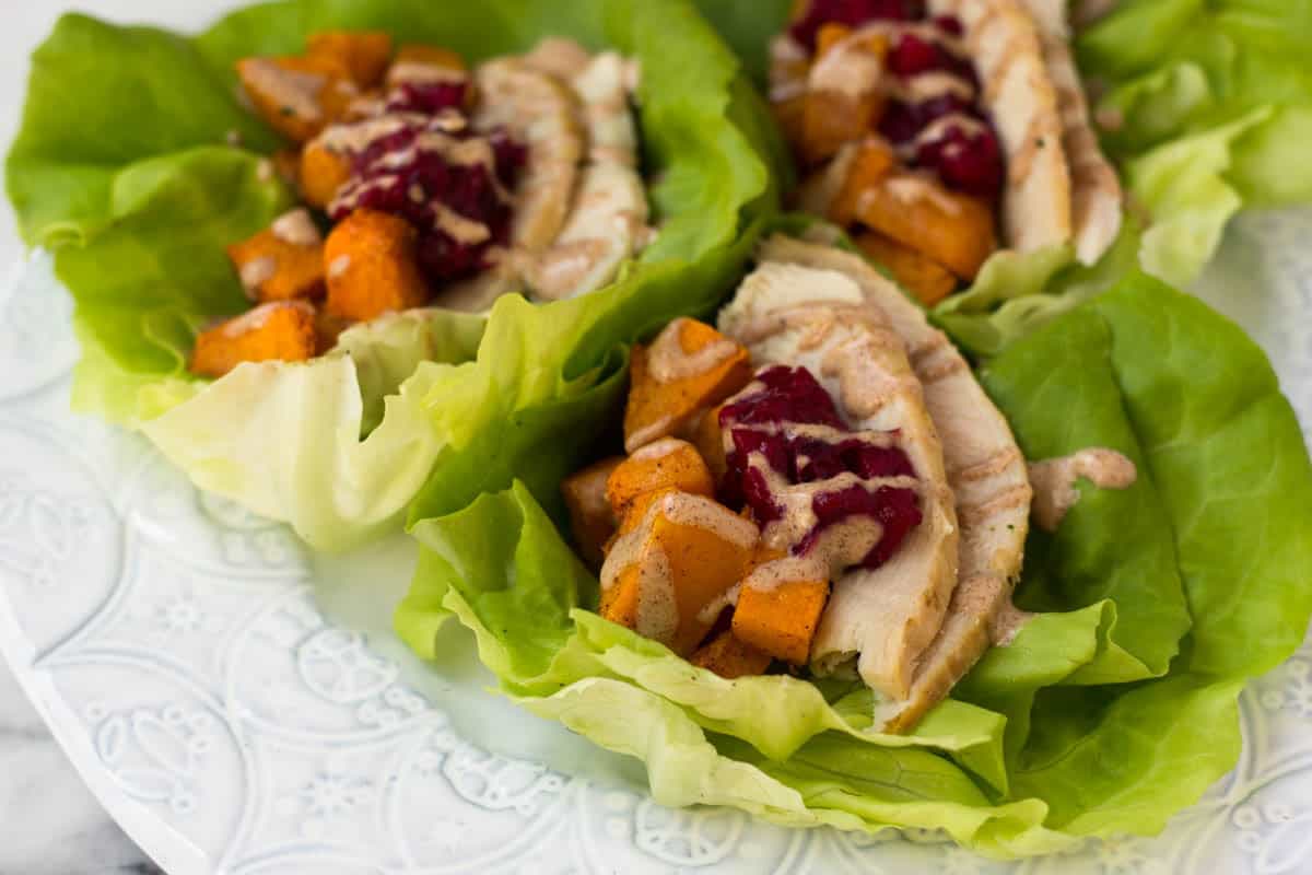 A lightened up version of your thanksgiving leftover sandwich, Turkey Cranberry Lettuce Wraps make a great low carb, gluten free, paleo, and Whole30 meal! - Eat the Gains