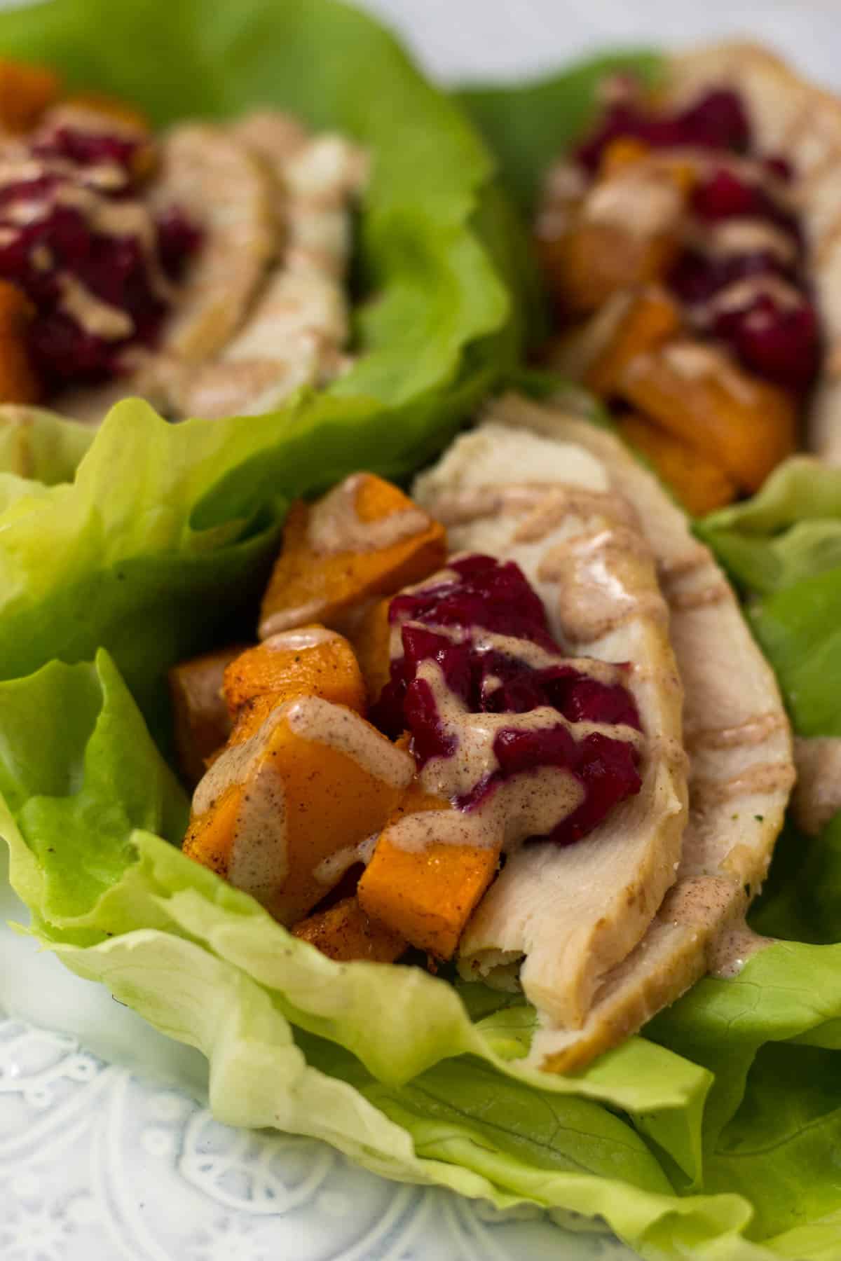 A lightened up version of your thanksgiving leftover sandwich, Turkey Cranberry Lettuce Wraps make a great low carb, gluten free, paleo, and Whole30 meal! - Eat the Gains
