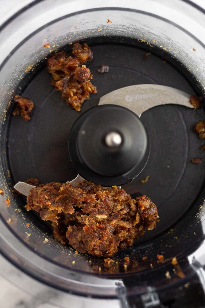 Food processor with broken up dates in it.
