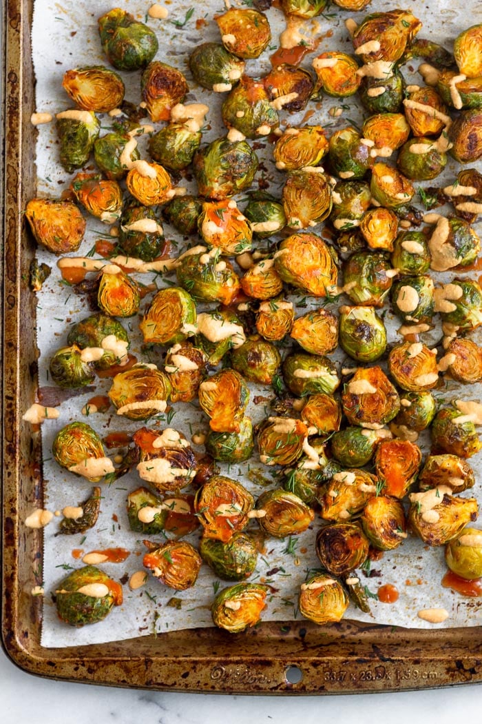 Best sprout recipe topping with fresh dill and cheesy buffalo sauce on a large baking sheet.