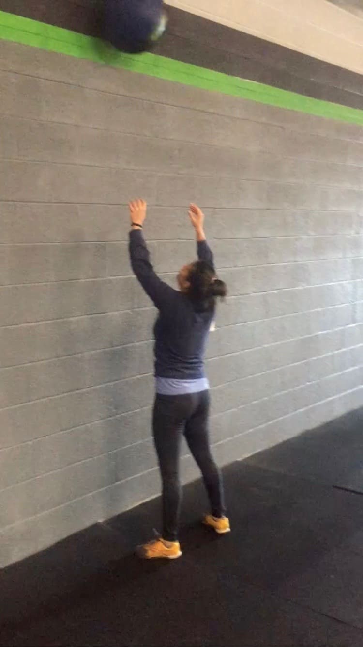 Girl doing a wallball in CrossFit