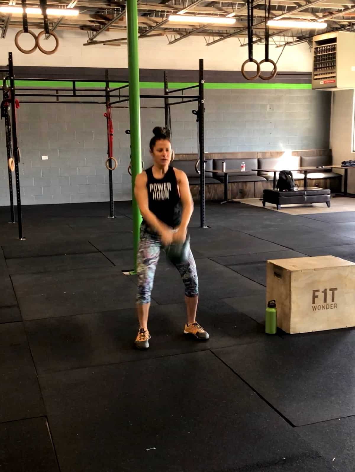 girl doing a kettlebell swing