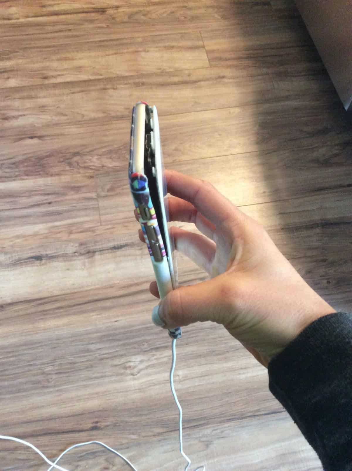iPhone with the screen coming off of it