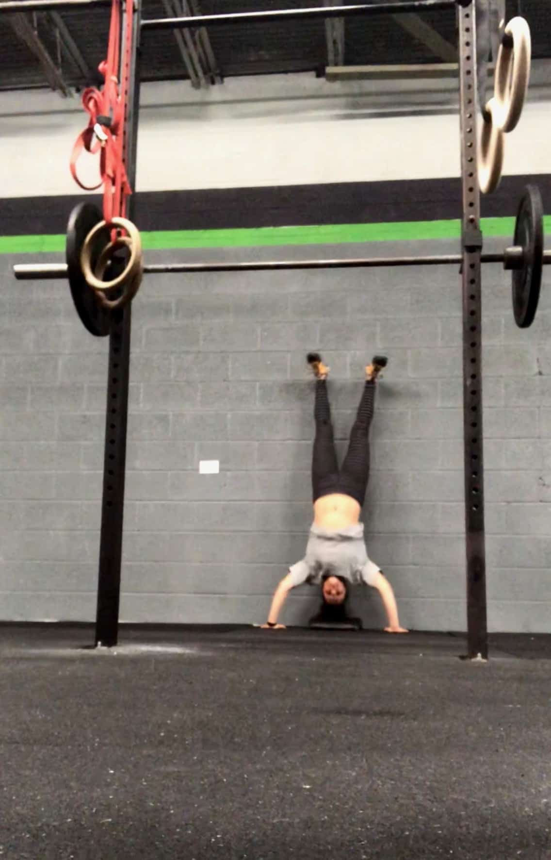 Girl upside-down doing a handstand push-up