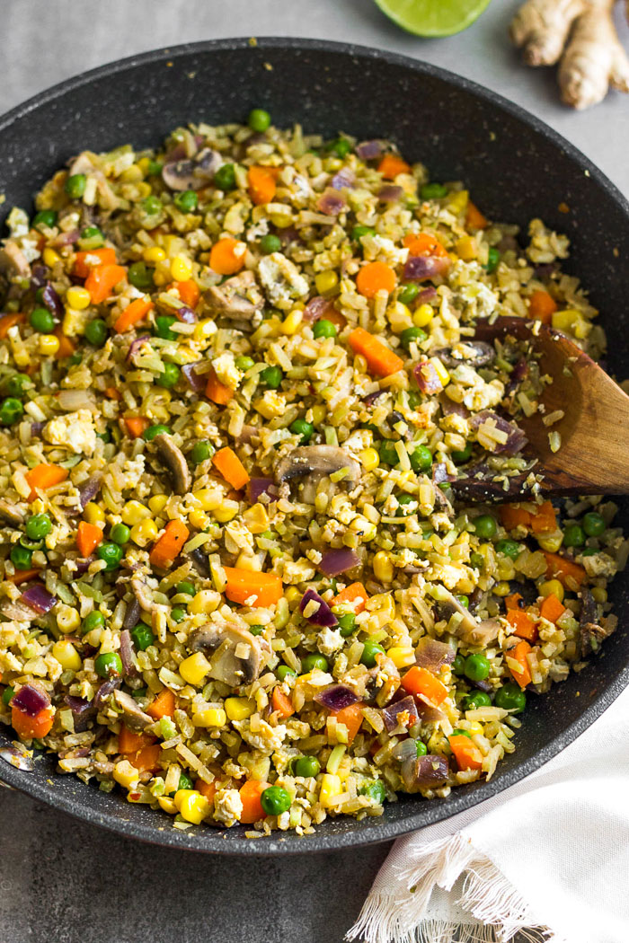 Large pan filled with riced broccoli fried rice.